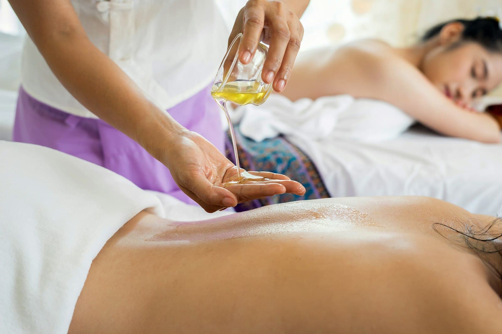 Couple receiving side-by-side massages