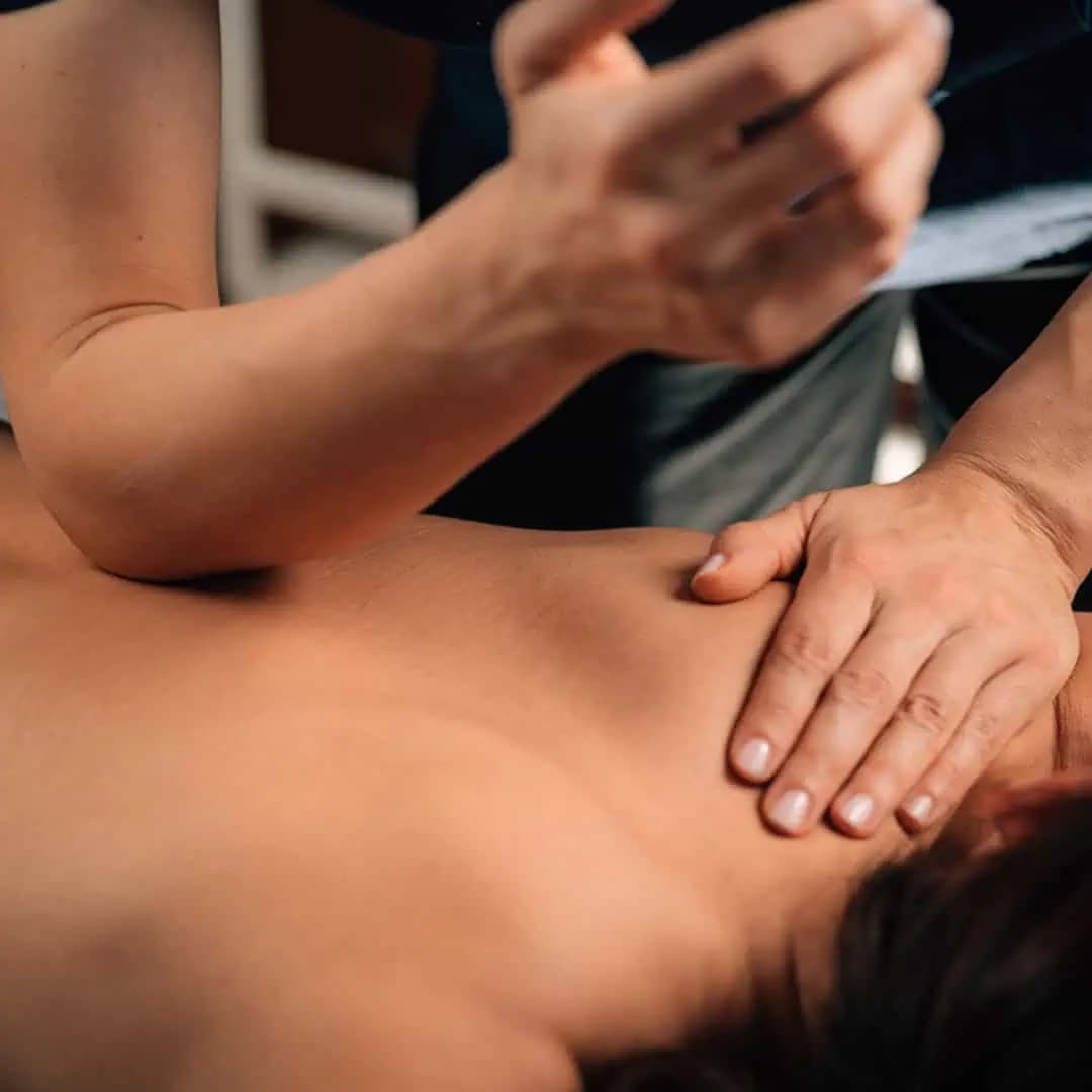 Therapist performing therapeutic massage on a relaxed client